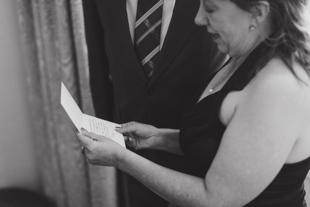 groom's parents reading a letter at the fairmont banff springs hotel from nicole sarah, wedding photographer in calgary