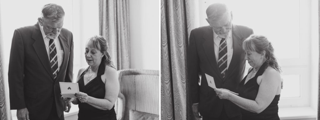 groom's parents reading a letter at fairmont banff springs hotel from nicole sarah, wedding photographer in calgary