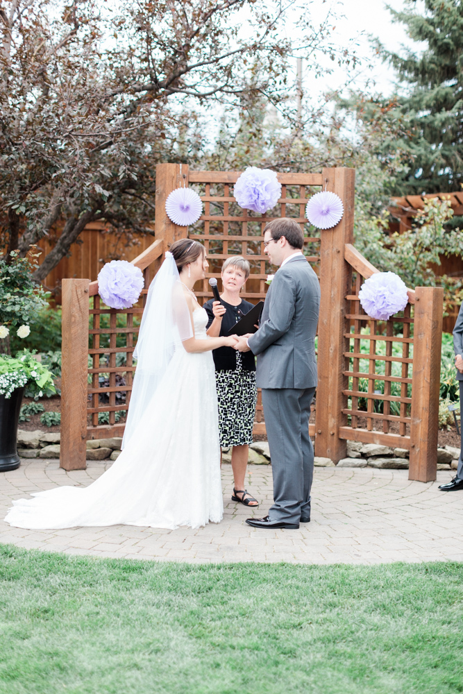 couple saying vows, wedding ceremony calgary zoo by nicole sarah photography