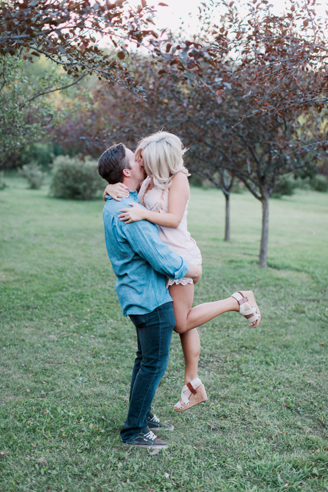 sunset engagement photography, pastel, kissing and spinning