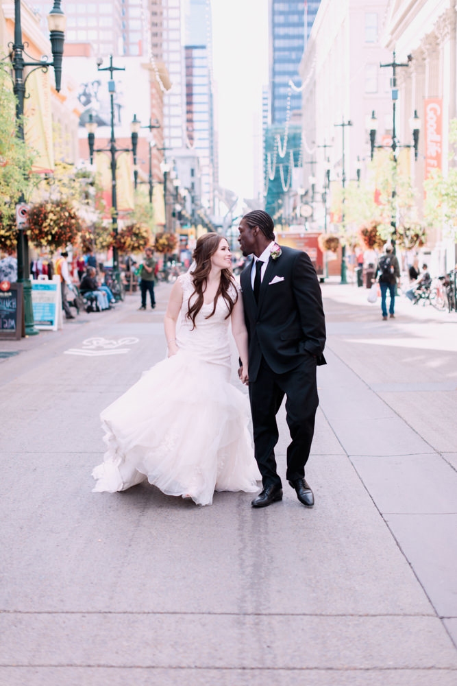 rooftop wedding, cherry blossoms, urban wedding photos, calgary wedding photographers, bride groom walking