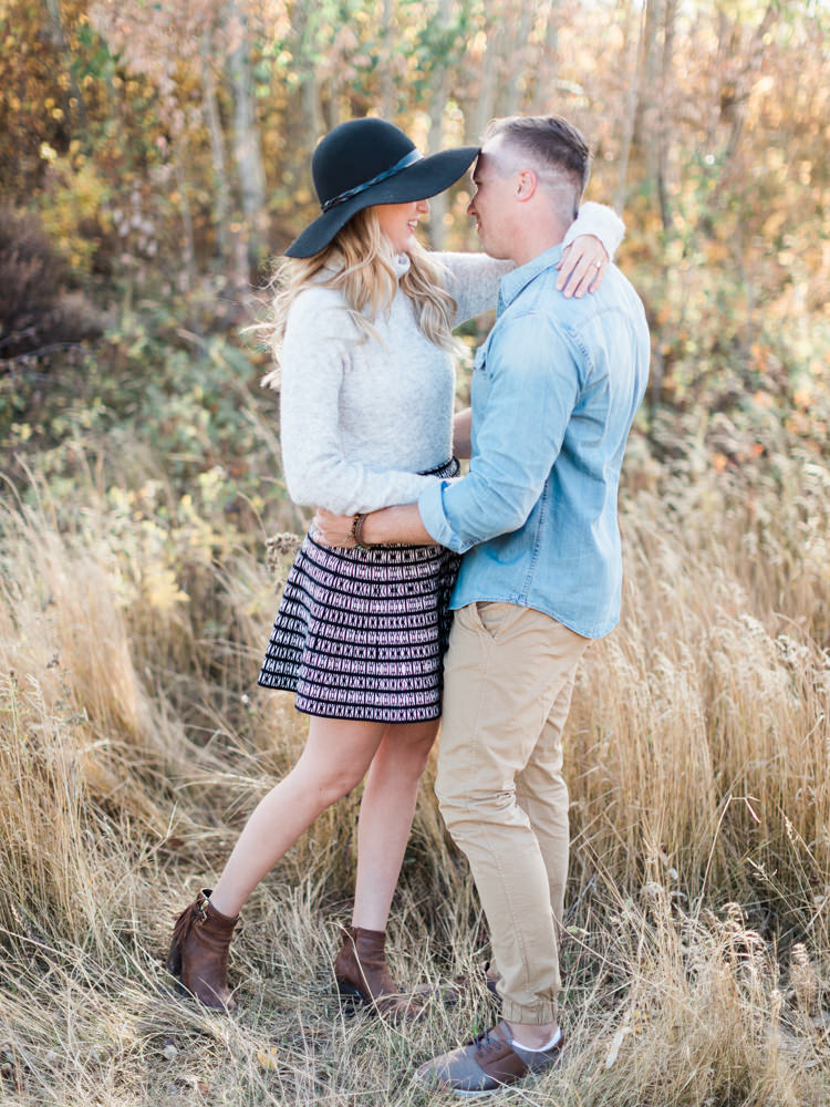 autumn sunset engagement, black floppy hat, black hat engagement, oval wedding ring, oval engagement ring, fall engagement photos, fall engagement ideas, fall engagement poses, fall engagement, film photography, film photographer, style me pretty, cozy autumn engagement, cozy engagement, engagement wardrobe fall, fall engagement clothing, warm sweater photo session, hot chocolate engagement, ring photos, ring goals, engagement rings, sunset photo, camping engagement theme