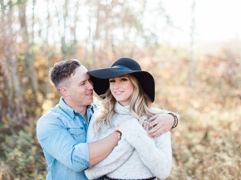 autumn sunset engagement, black floppy hat, black hat engagement, oval wedding ring, oval engagement ring, fall engagement photos, fall engagement ideas, fall engagement poses, fall engagement, film photography, film photographer, style me pretty, cozy autumn engagement, cozy engagement, engagement wardrobe fall, fall engagement clothing, warm sweater photo session, hot chocolate engagement, ring photos, ring goals, engagement rings, sunset photo, camping engagement theme