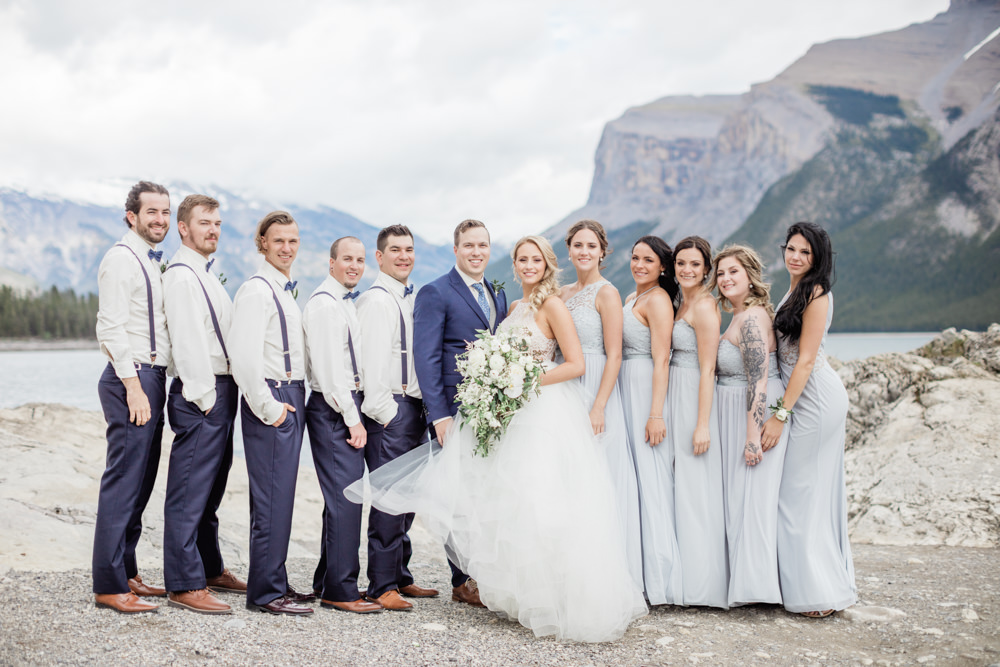 canmore wedding photographer, banff wedding photographer, calgary wedding photographer, crop top wedding dress, mountain wedding, film wedding, outdoor mountain wedding ceremony, large flower bouquet, navy groom suit, sage bridesmaid gowns, groom crying, bridesmaids laughing, bridesmaid inspiration, powder blue bridesmaid gown, two piece bride gown, tulle skirt, watters skirt, theia skirt, beaded crop top, summer wedding, mountainscape wedding, romantic rocky mountain wedding, love in the rockies