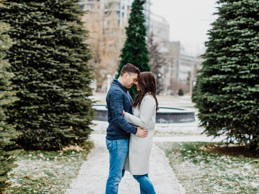 winter engagement, winter photos, christmas engagement, engagement ideas, engagement outfit ideas, grey wool coat, wool coat, snow, wintery engagement, getting married, winter engagement photos outfits, engagement poses, photography poses, romantic poses, how to pose, couple kissing, playing in the snow, nicole sarah, calgary landmarks, calgary christmas, events in calgary, wedding photographers nicole sarah, christmas engagement pictures, xmas engaged, mansion engagement, urban engagement setting, urban backdrop