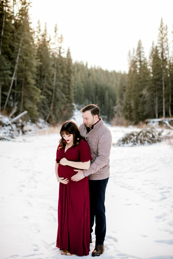 maternity session, calgary, nicole sarah, winter baby photos, red dress, mom to be photos, forest family photos, maternity photos in the forest, maternity poses, affordable maternity photographers