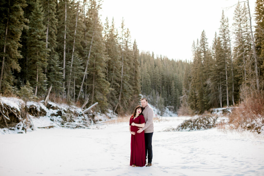 maternity session, calgary, nicole sarah, winter baby photos, red dress, mom to be photos, forest family photos, maternity photos in the forest, maternity poses, affordable maternity photographers