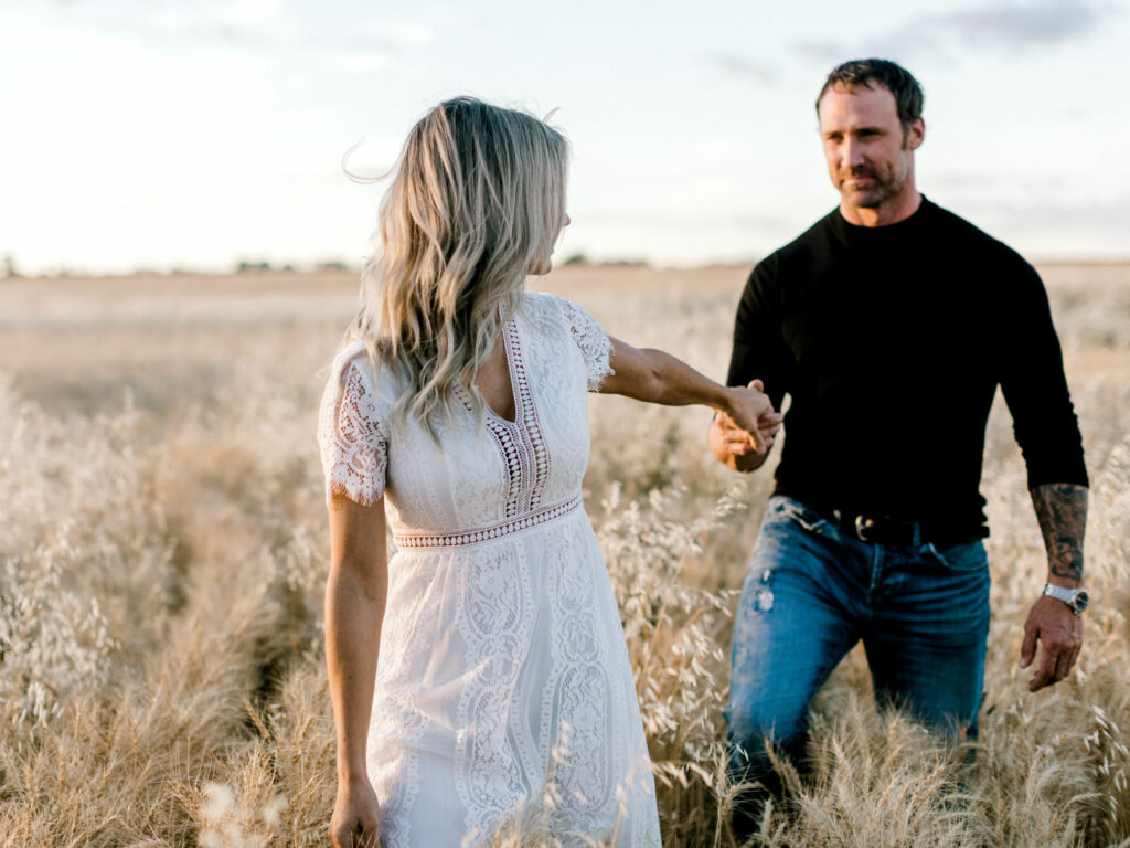 couple in wheat field, riverside engagement, calgary, nicole sarah, sunset engagement photos, fall romance, engagement photography fall, couple cuddling, couple laughing, white dress, white dress engagement, edmonton engagement photographer