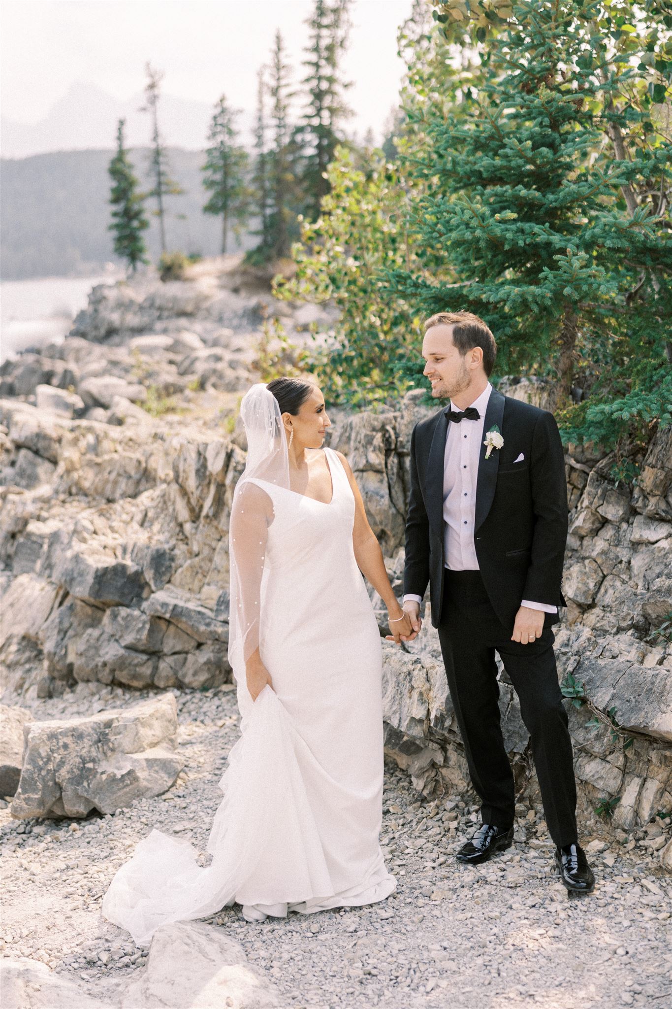 lake minnewanka wedding, mountain wedding photos, banff lake wedding, blue lake banff wedding photos, bride groom walking