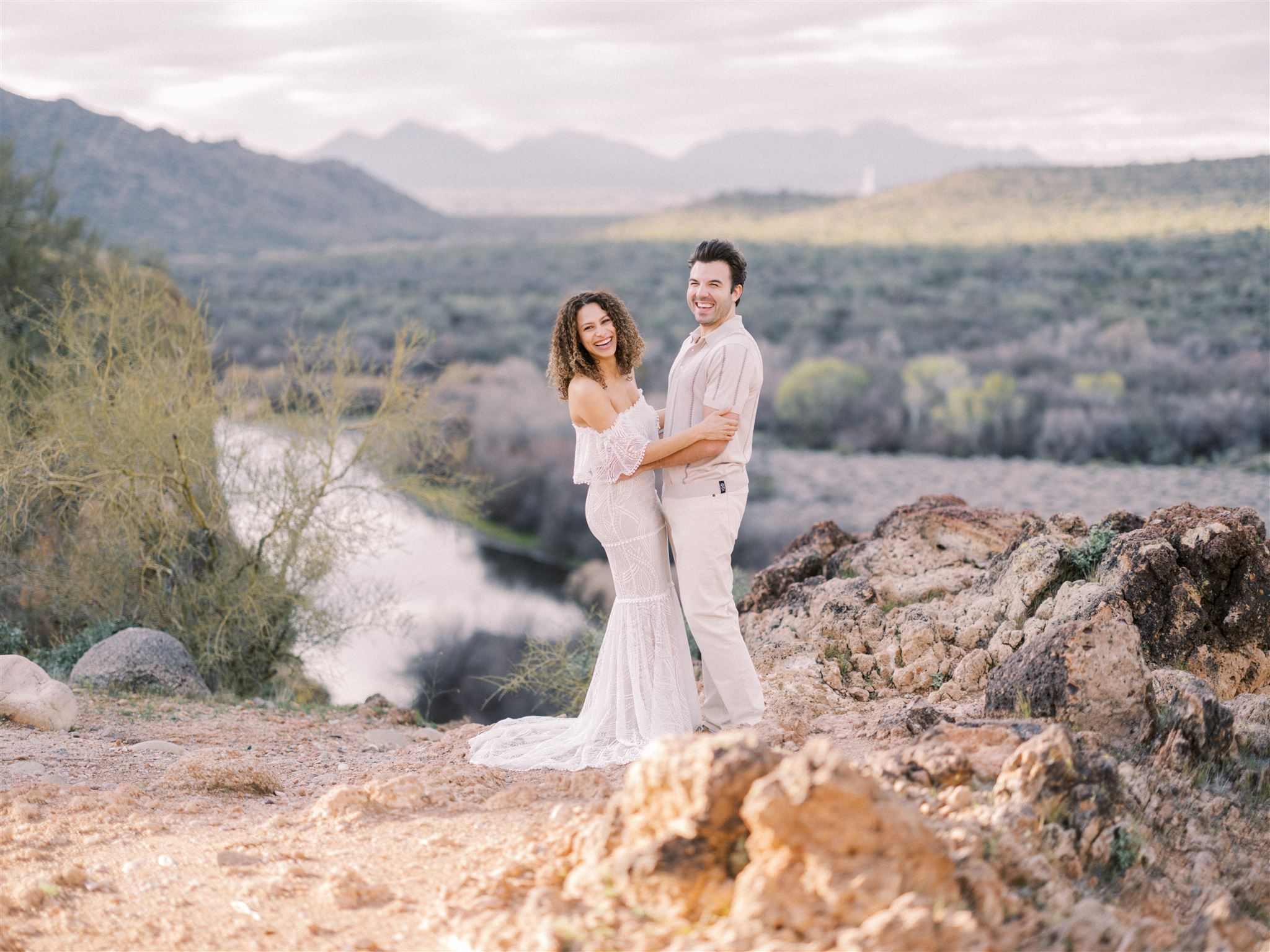 Desert Canyon Engagement Nicole Sarah, bride laughing, bride in white dress, white dress engagement, couple on cliff