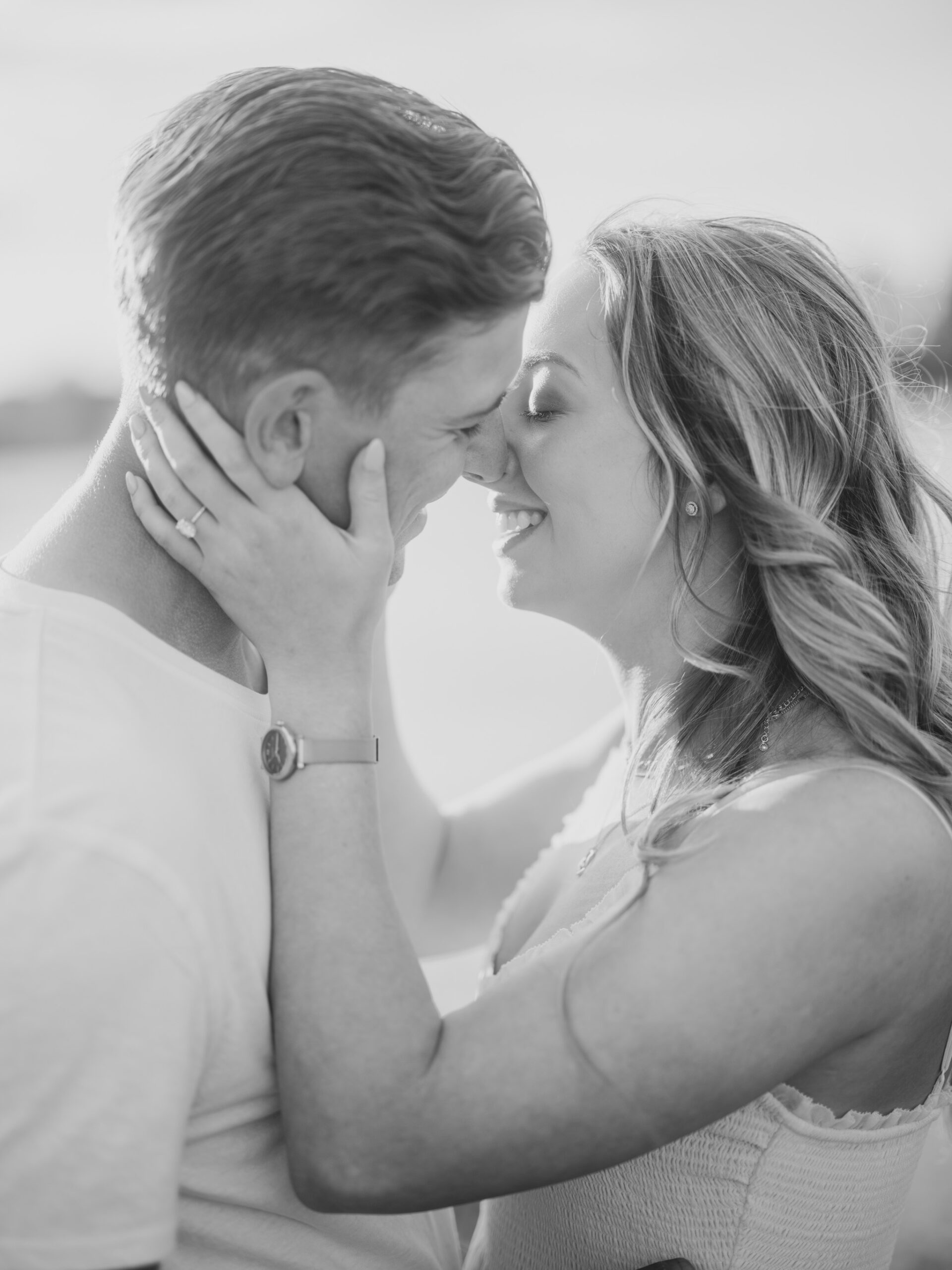 Cherry Blossom Spring Engagement Session, river engagement couple laughing, couple embracing, engagement pose sunset, sunset engagement photos, labrador retriever engagement photos, dog engagement session, puppy engagement session, alberta wedding photographers, alberta photographer, calgary wedding, calgary wedding photographer, spring engagement session, spring photos, nicole sarah, cherry blossom photos, cherry blossom engagement, wedding poses, white dress engagement, sundress white, engagement photos, bow river, puppy engagement photos, neutral engagement photos