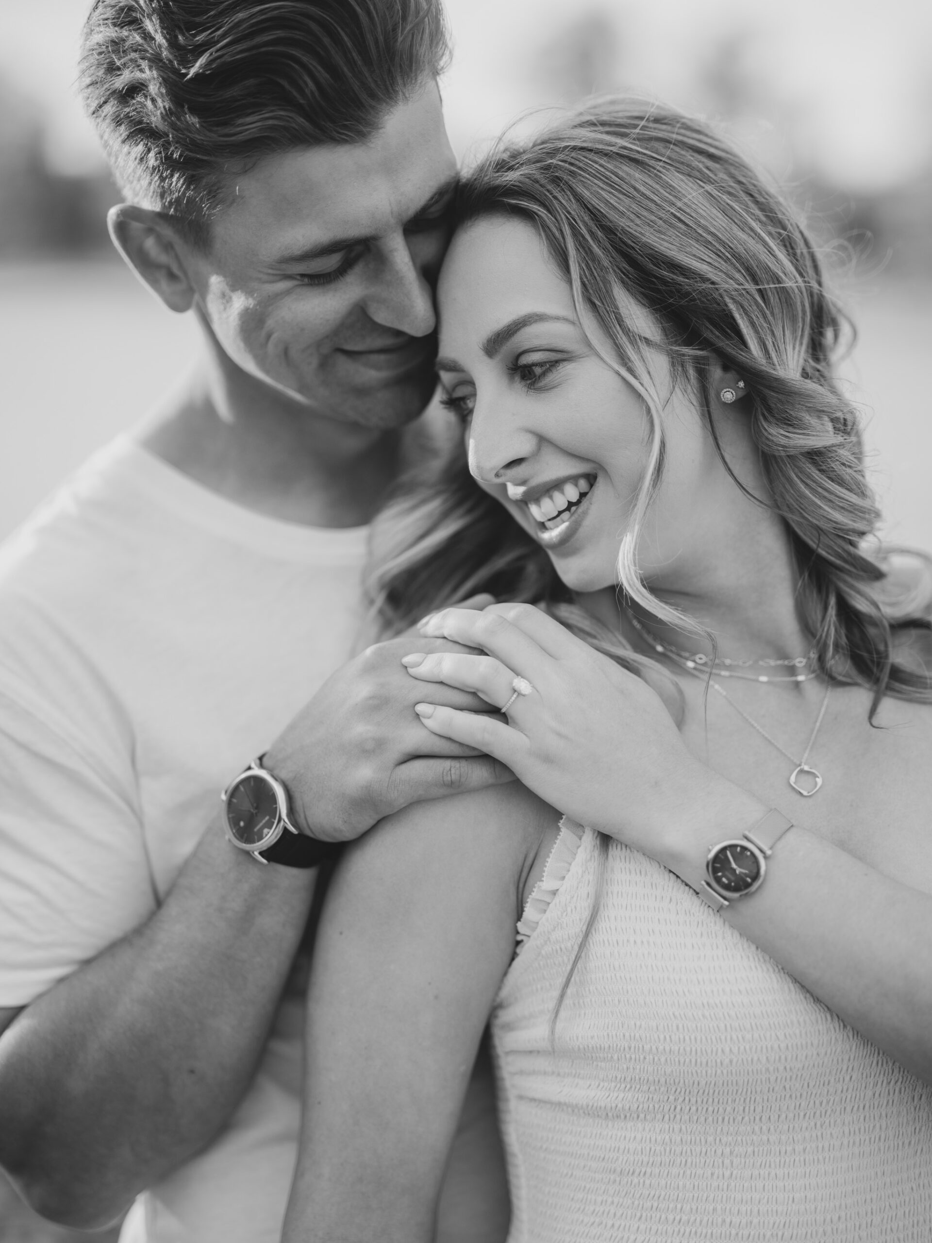 Cherry Blossom Spring Engagement Session, river engagement couple laughing, couple embracing, engagement pose sunset, sunset engagement photos, labrador retriever engagement photos, dog engagement session, puppy engagement session, alberta wedding photographers, alberta photographer, calgary wedding, calgary wedding photographer, spring engagement session, spring photos, nicole sarah, cherry blossom photos, cherry blossom engagement, wedding poses, white dress engagement, sundress white, engagement photos, bow river, puppy engagement photos, neutral engagement photos