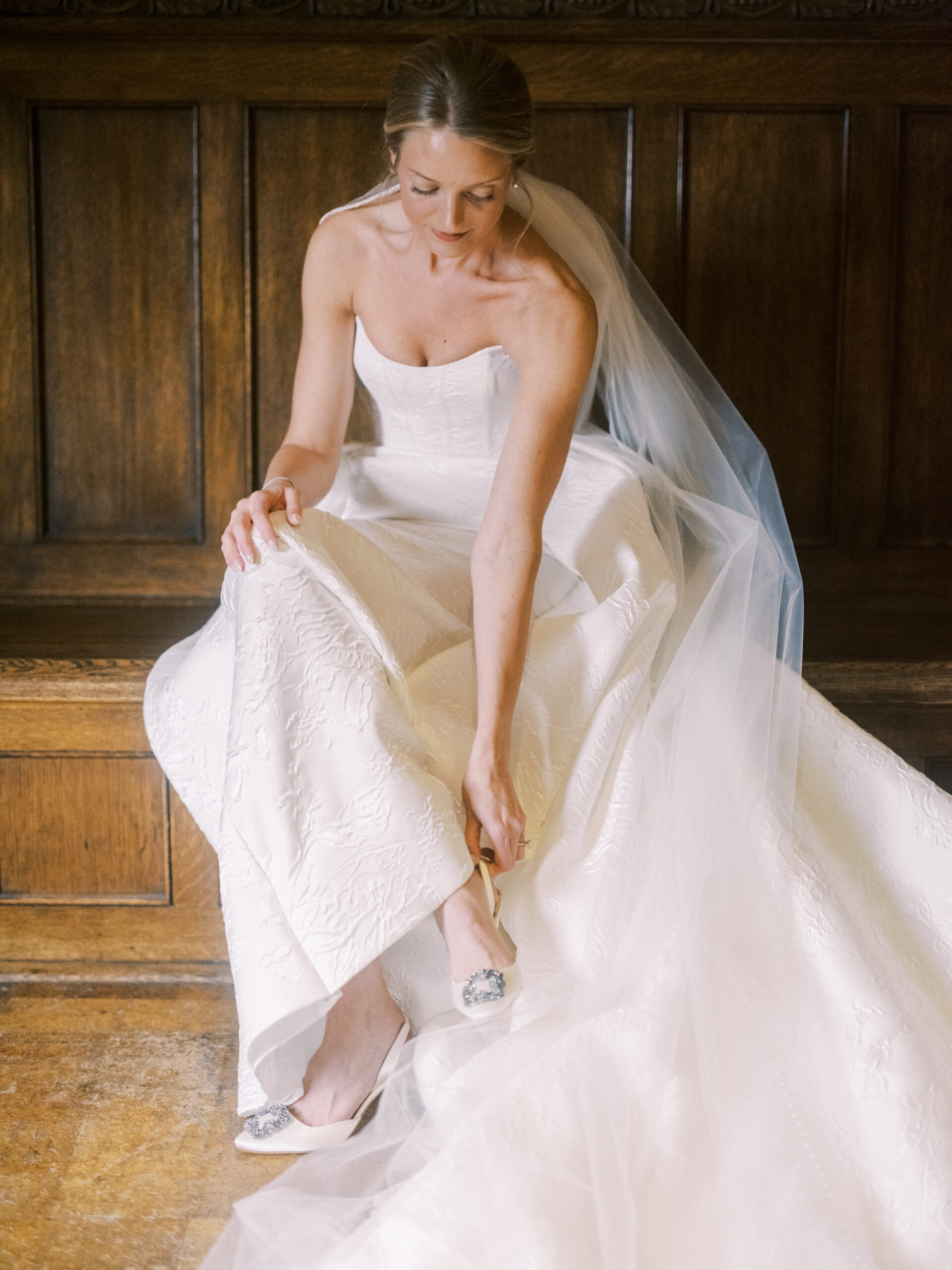 bride putting on shoes, fairmont banff springs wedding, luxury wedding, destination wedding photographer nicole sarah, ralph lauren polo bar wedding, winter wedding, mountain wedding, rocky mountain weddings