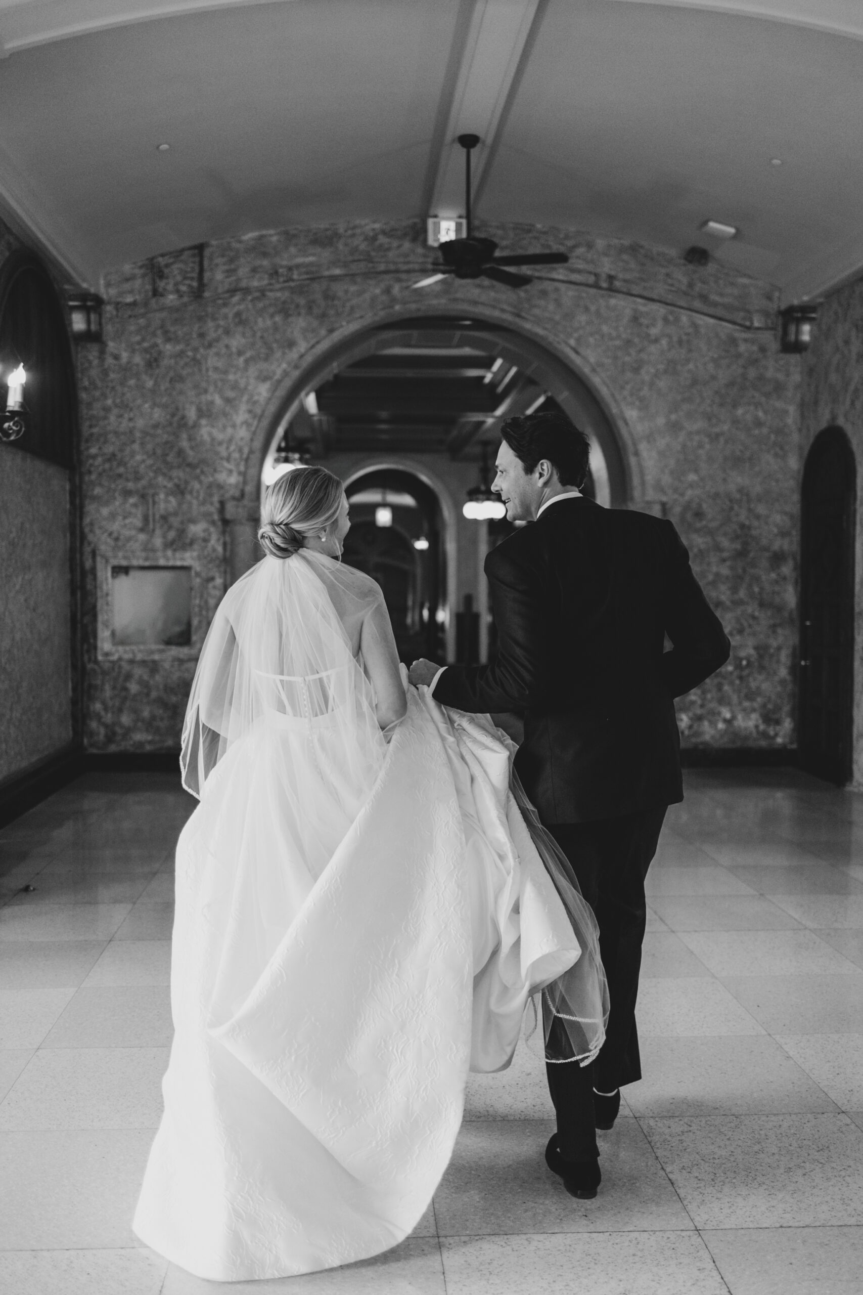 couple walking, black white wedding photo, fairmont banff springs wedding, luxury wedding, destination wedding photographer nicole sarah, ralph lauren polo bar wedding, winter wedding, mountain wedding, rocky mountain weddings