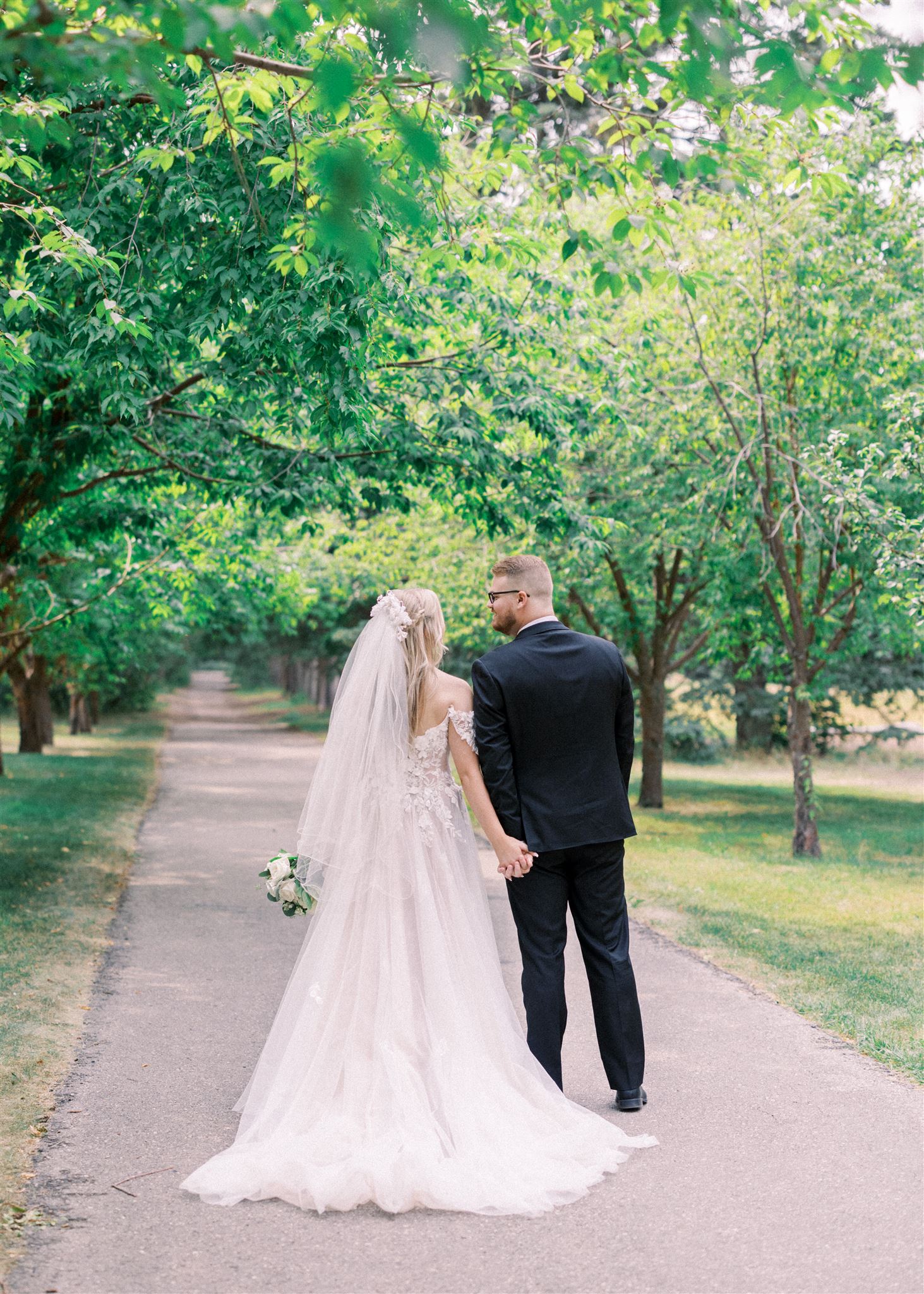 Waterfront Park Summer Calgary Wedding, lace wedding dress, nicole sarah, film wedding photography, film wedding photos, luxury wedding photographer calgary, romantic wedding portraits, alberta wedding photographers, lush greenery wedding photography, bride groom poses