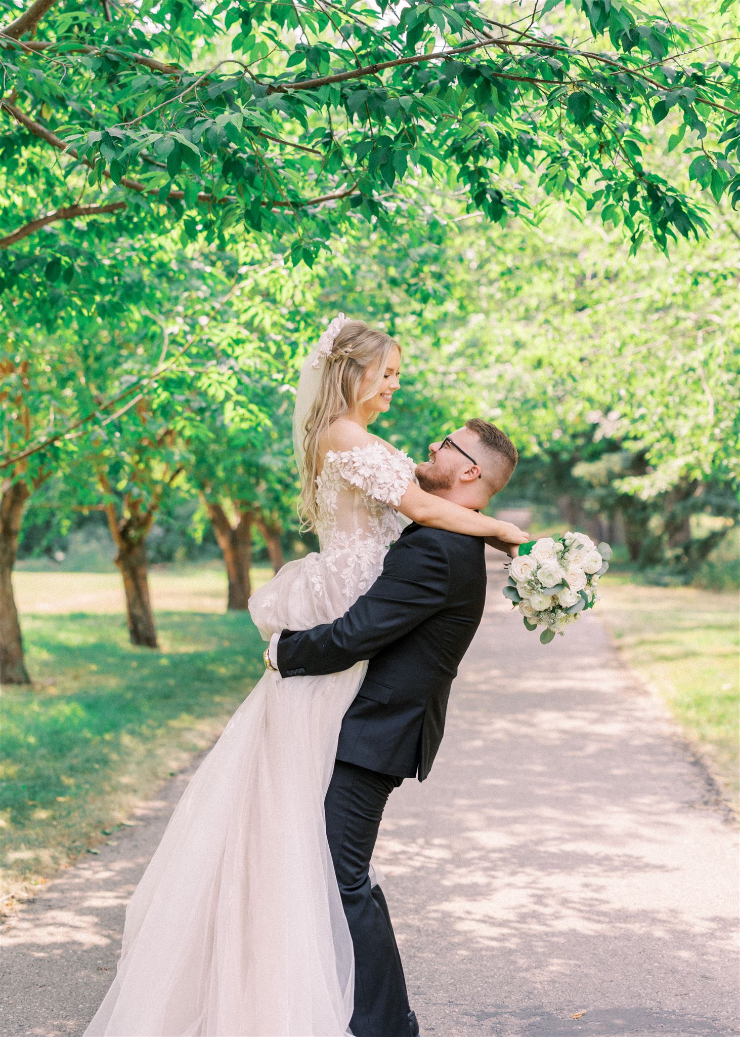 Waterfront Park Summer Calgary Wedding, lace wedding dress, nicole sarah, film wedding photography, film wedding photos, luxury wedding photographer calgary, romantic wedding portraits, alberta wedding photographers, lush greenery wedding photography, bride groom poses