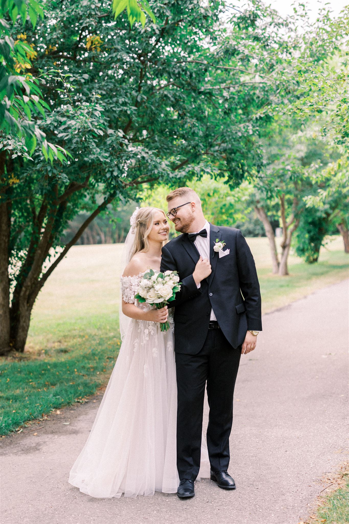 Waterfront Park Summer Calgary Wedding, lace wedding dress, nicole sarah, film wedding photography, film wedding photos, luxury wedding photographer calgary, romantic wedding portraits, alberta wedding photographers, lush greenery wedding photography, bride groom poses