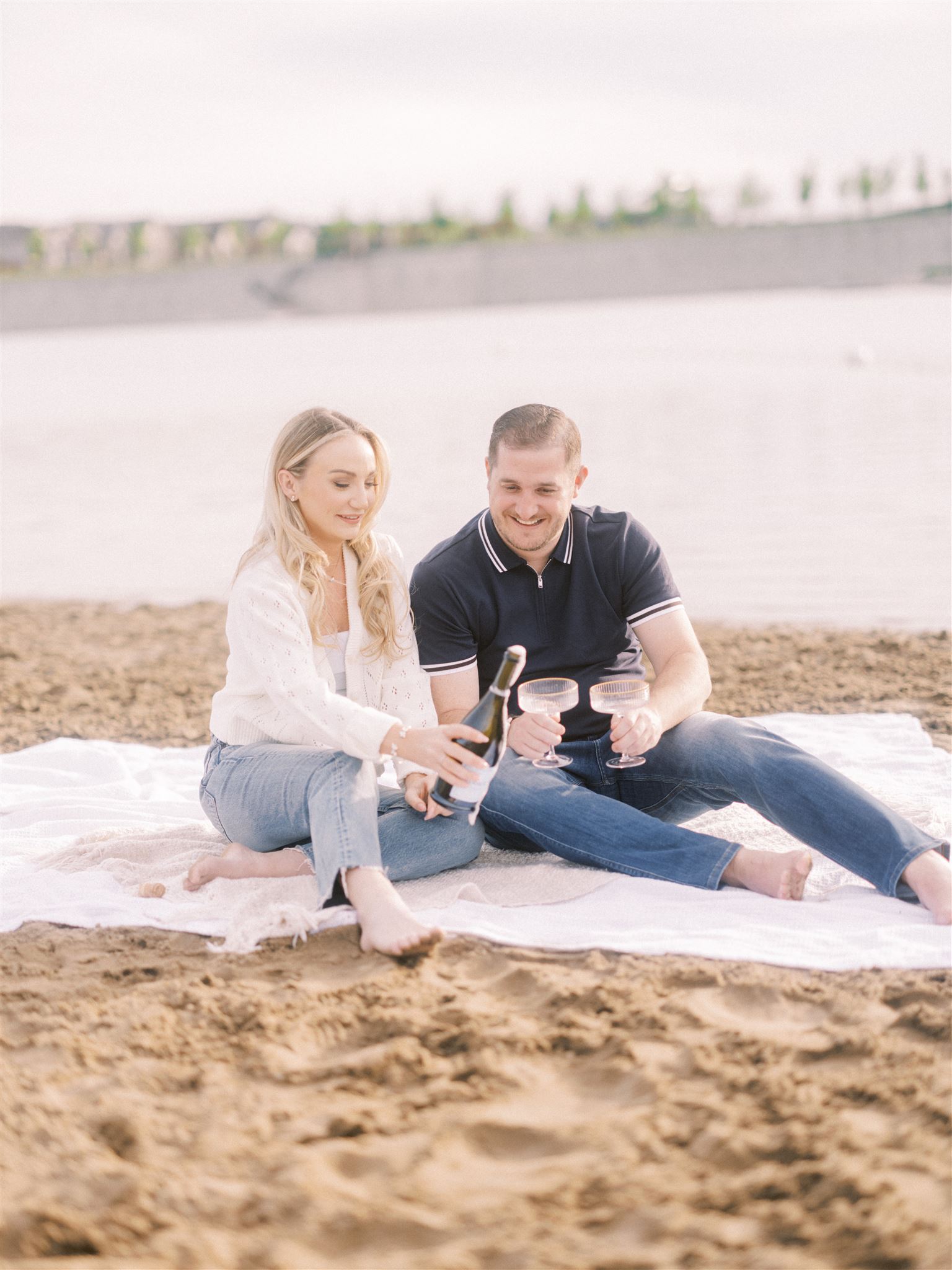 Summer Beach Engagement Calgary, beach engagement, summer engagement, cute summer engagement, sunset engagement on the beach, nicole sarah, couple cuddling on the beach, summer beach engagement outfits, engagement poses beach, running on the beach engagement