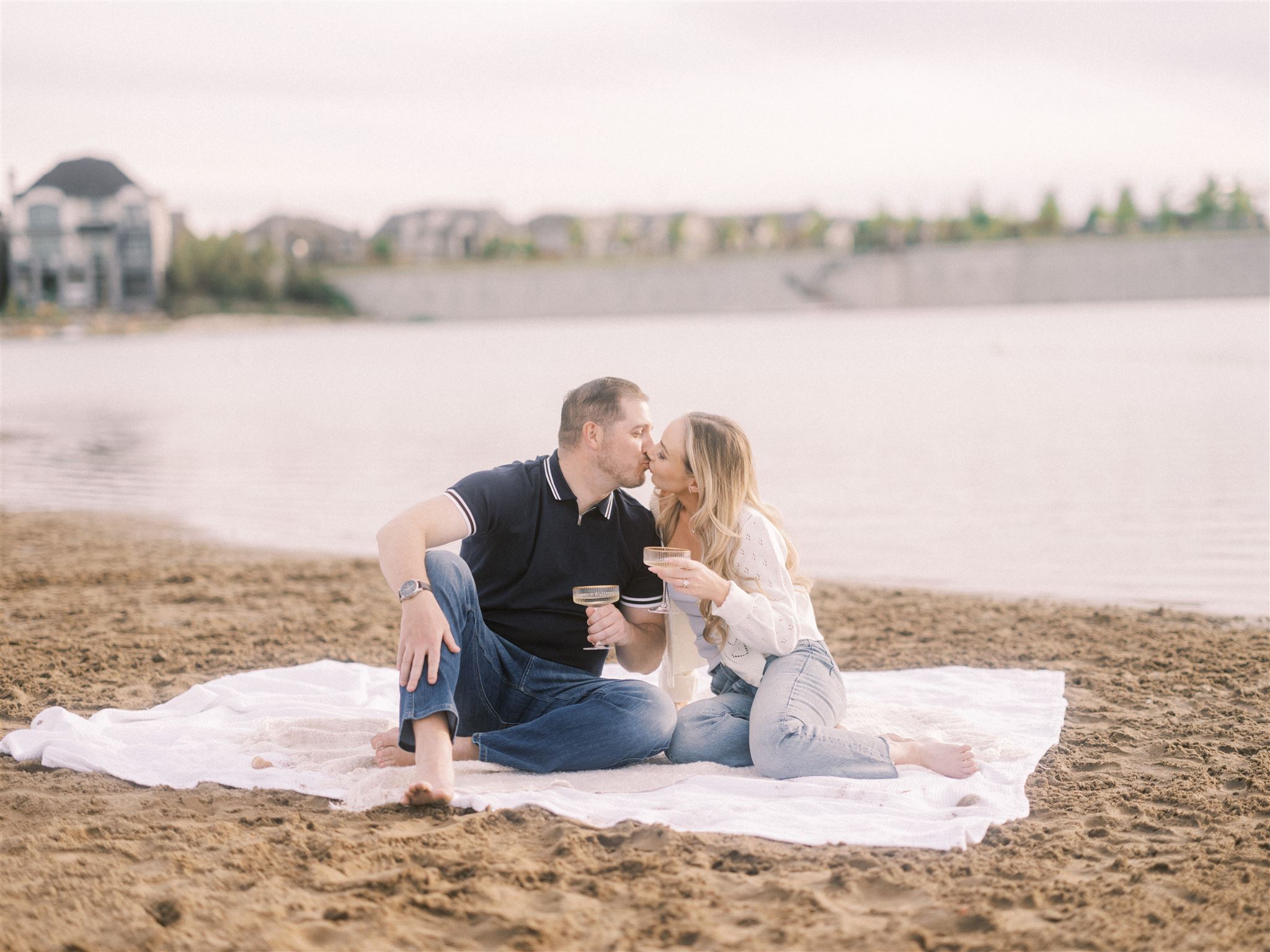 Summer Beach Engagement Calgary, beach engagement, summer engagement, cute summer engagement, sunset engagement on the beach, nicole sarah, couple cuddling on the beach, summer beach engagement outfits, engagement poses beach, running on the beach engagement