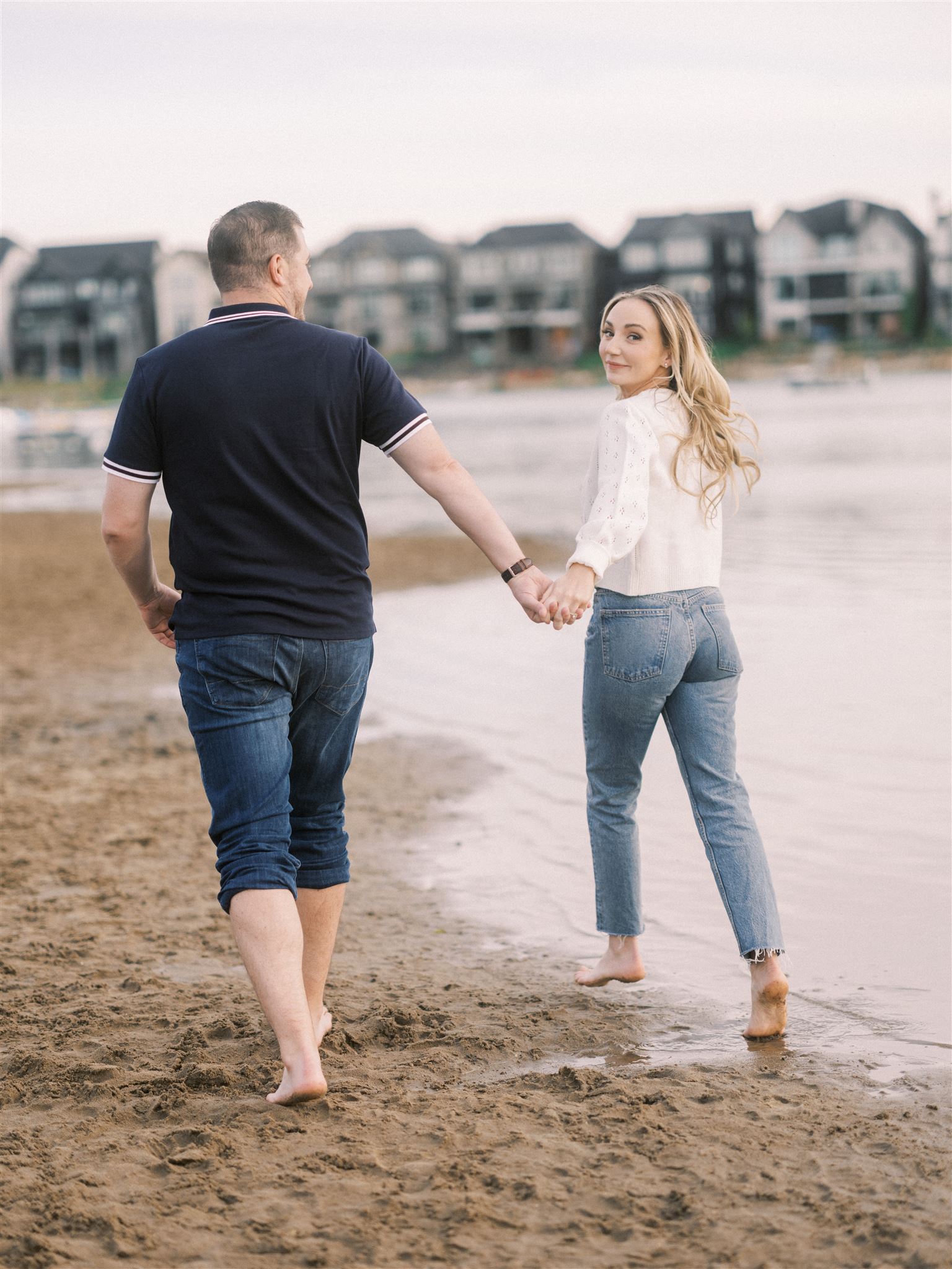 beach engagement, summer engagement, cute summer engagement, sunset engagement on the beach, nicole sarah, couple cuddling on the beach, summer beach engagement outfits, engagement poses beach, running on the beach engagement