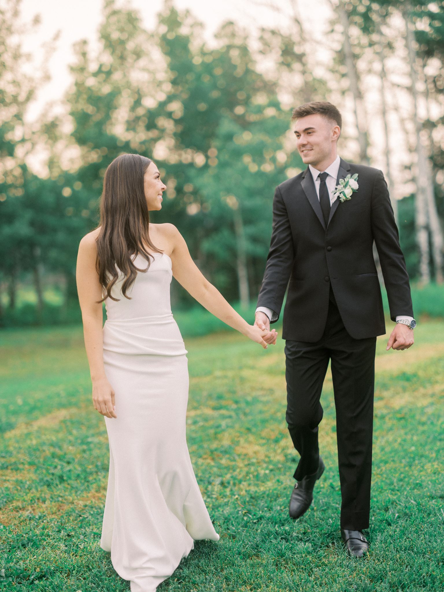 bride walking with groom at sunset, sunset wedding photos, film wedding at sunset, bride leading groom holding his hand