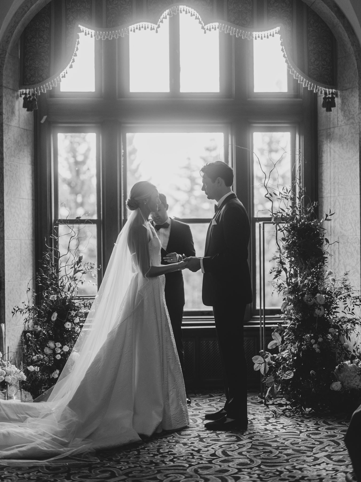 black and white bride and groom first kiss, glowing black and white photo wedding, soft romantic first wedding kiss photo, bride and groom wedding ceremony black and white